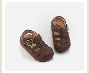 Detailed close-up of vintage brown suede toddler fisherman sandals with gold buckles.