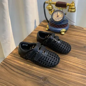 Detailed view of black woven mesh Mary Jane shoes for girls with breathable cut-out design.
