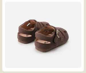Detail view of the back and heel of brown suede retro Roman sandals for children.