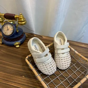 Detail view of white woven mesh Mary Jane shoes with breathable mesh and Velcro strap.
