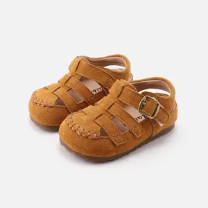 Retro brown suede toddler Roman sandals with closed-toe hollow design and soft soles.