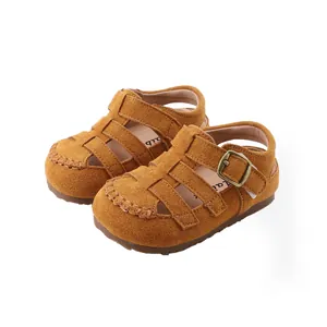 Brown suede children's Roman sandals featuring soft soles and a closed-toe design.