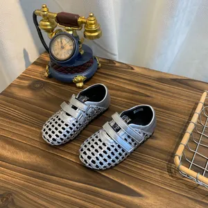 Silver woven Mary Jane sandals with breathable mesh design and Velcro straps
