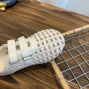 Macro detail of breathable woven mesh Mary Jane shoe with stylish cream velcro straps