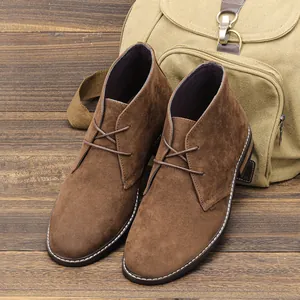 Gros plan de bottines désert en daim marron pour hommes avec des coutures blanches