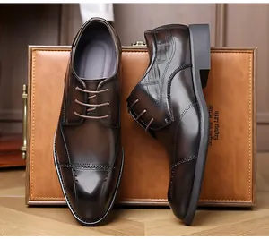 Close-up of dark brown business dress shoes with elegant brogue and textured details