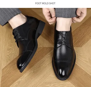 High-angle detail shot of men's black leather brogue dress shoes on a wooden floor