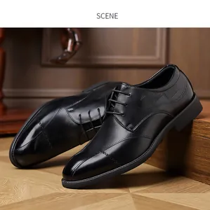 Detail view of black leather brogue dress shoes on a wooden background