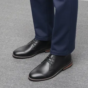 Detail view of men's black leather desert boots with vintage stitching