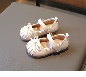 Elegant white girls' Mary Jane princess shoes with a bow detail and hook-and-loop strap.