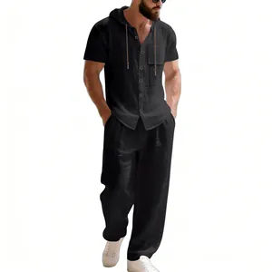 Full-body view showing the relaxed fit of the men's black linen hooded shirt and pants