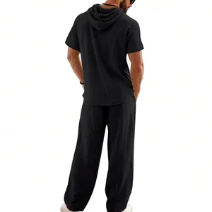 Detailed back view of men's black linen short sleeve hooded shirt and matching trousers