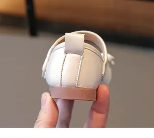 Close-up rear view showing the heel structure of a white leather girl's princess shoe