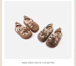 Detailed top view of two pairs of cute cartoon baby sandals with soft rubber soles