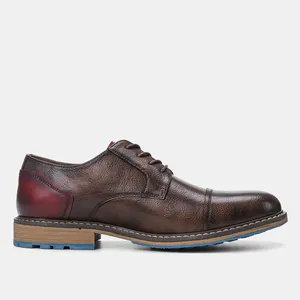 Side view of vintage brown textured leather dress shoes with burgundy heel detail