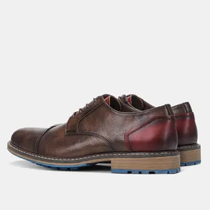 Rear-side view of vintage brown men's leather shoes with red heel and blue sole detail