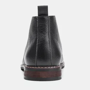 Vue arrière détaillée de bottes désert en cuir noir avec tirette au talon et fini texturé