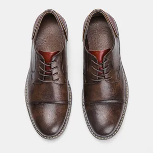 Detailed top view of vintage brown leather dress shoes with cap toe and stitch details