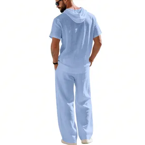 Back view of men's loose light blue linen hooded shirt and breathable long pants set