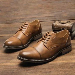 Detail of vintage brown men's cap toe oxfords placed on a rustic wooden background