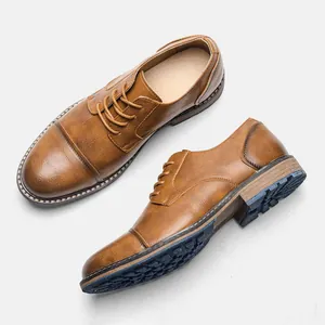 Detail of vintage brown men's leather shoes showing cap-toe design and textured rubber sole
