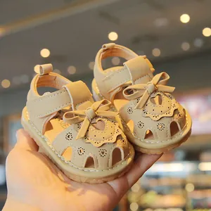 Toddler girl beige summer sandals featuring a decorative bow and heart hollow-out design