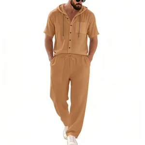 Detail view of a men's tan linen hooded short-sleeve shirt and matching pants set.