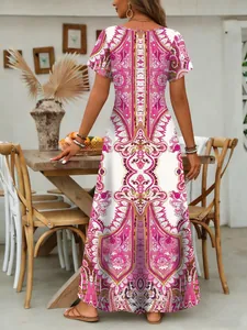 Detailed back view of a summer maxi dress with intricate pink paisley patterns.