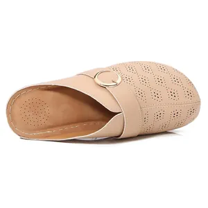 Beige closed toe mules for women with laser-cut hollow pattern and gold buckle detail