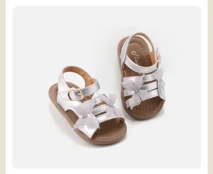 Detailed view of silver toddler sandals featuring elegant lace butterfly decorations