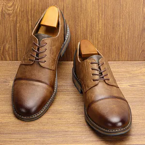 Macro view of vintage brown leather dress shoes with decorative stitching details.