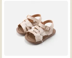 Detailed view of girls' cream sandals with elegant lace butterfly and metal buckle.