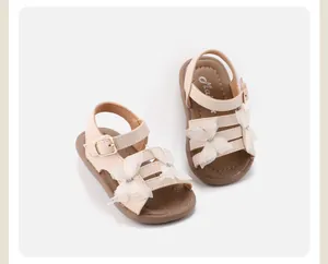 Top-down view of beige toddler sandals with lace butterfly decoration