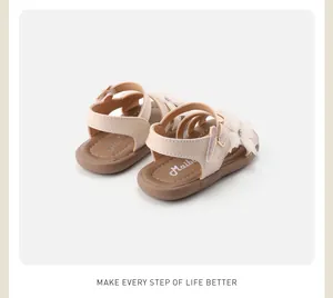 Close-up of elegant beige toddler sandals with delicate floral accents and crystal details.