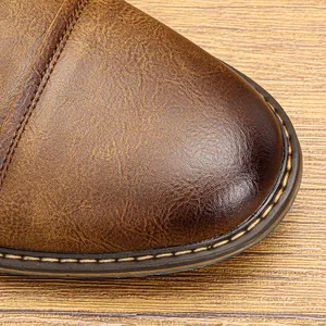 Close-up macro view of vintage brown leather shoe toe with detailed stitching and texture
