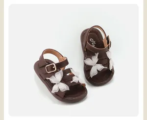 Dark brown toddler girl sandals featuring white lace butterflies and adjustable buckle straps