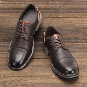 Detail of vintage brown leather men's dress shoes on a rustic wooden background.