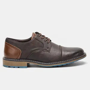 Side profile of vintage brown two-tone men's leather dress shoes with blue sole accent