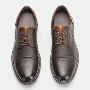 Detailed top view of vintage brown men's leather dress shoes with lace-up design
