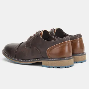 Detailed rear side view of brown vintage men's dress shoes with blue sole accents