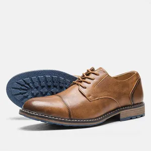 Side view of brown leather men's dress shoes featuring a blue non-slip textured sole.