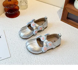 Elegant silver girls Mary Jane princess shoes with pink floral accents and cross straps