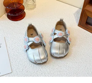 Silver girls Mary Jane shoes featuring floral cross straps and delicate crochet flower details