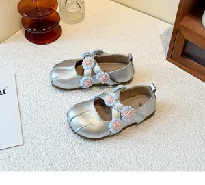 Detailed view of silver girls' Mary Jane shoes with delicate pink and blue floral accents.