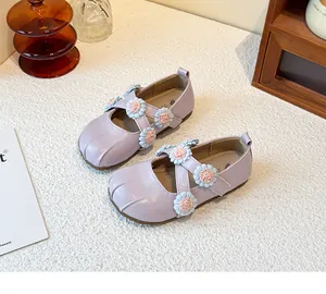 Detailed view of light purple girl's Mary Jane shoes with decorative floral cross straps.