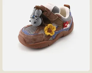 Close-up detail of a toddler sport shoe featuring a cute knit rabbit and floral accents.