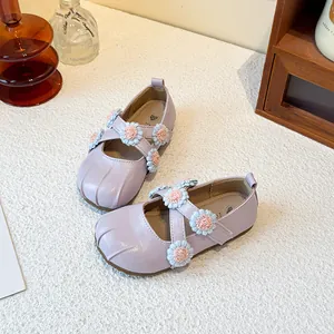 Elegant purple Mary Jane shoes for little girls featuring floral accents and cross straps.