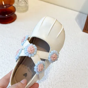 Elegant white Mary Jane shoes for girls featuring crochet flower accents and cross straps.