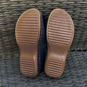 Detail view of non-slip rubber outsoles on women's platform clogs, size 37 mark visible.