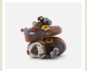 High quality close-up of brown baby sneakers with knitted flower and bunny motifs